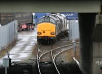 A container train unloading at WHM Grangemouth on 15 January 2005. At the head of the train are DRS class 37 locomotives 37218 (nearest) and 37602. View is south west below the M9 Motorway overbridge.<br><br>[John Furnevel 15/01/2005]
