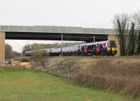 Trans-Pennine 350401 and 350403 form a Manchester Airport to Glasgow service seen passing under the new Heysham Link Road bridge at Morecambe South Junction on 1st April 2016. This was the day that First Group took sole responsibility for the TPE franchise having previously been in partnership with Keolis.  <br><br>[Mark Bartlett 01/04/2016]