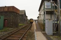 A Carlisle to Barrow Class 153 railcar attached to a Class 142 calls at Foxfield on 11 March 2016. Access to the island platform is via a board crossing at the north end of the station. The water tank on the left looks complete but I don't know if it still has a use.<br><br>[John McIntyre 11/03/2016]