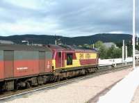 An Inverness bound parcels train held at the north end of Aviemore station under a heavy sky on 25 September 2004. EWS 67024 is the locomotive in charge. <br><br>[John Furnevel 25/09/2004]