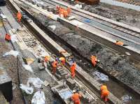 The 'orange army' busy on the north end of platforms 1 and 2 on 29th April 2016. Progress on realigning the platforms has been rapid, with track components and ballast delivered by rail and other buiding materials craned down from Cathedral Street Bridge.<br><br>[Colin McDonald 29/04/2016]