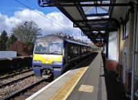 Recent timetable changes have beefed up Dumbarton's service, with trains extended from Dalmuir and using the normally quiet Platform 3. 320 313 waits with a Cumbernauld service on 30/04/2016.<br><br>[David Panton 30/04/2016]