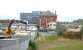 Site of Granton Gasworks in 2006, with the Edinburgh & Leith Gas Commissioners 1902 station building and platform still intact. The line ran alongside the wall through what was originally an open structure (now bricked up at both ends), with the platform connected by an internal stairway to the upper level. From there a footbridge spanned the sidings to access the works and offices off to the left. The new Scottish Gas HQ stands in the background beyond the station. [See image 10312]<br><br>[John Furnevel 16/08/2006]