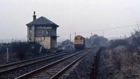 A 1980s view of Garnqueen South signal box in its original location before re-erection at Bo'ness. A train is making an exit from the Bedlay branch, as the Monkland and Kirkintilloch had become by this date. [See image 54242]<br><br>[Alastair McLellan //]