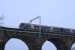 On a cold February afternoon, a Glasgow - Edinburgh DMU at speed passes the first set of OHLE masts to be fitted to the previously installed support brackets on the viaduct.<br><br>[Colin McDonald 13/02/2016]