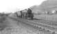 An up West Highland train passing through Dumbuck on Saturday 12 April 1958 with Black 5 44787 piloting K2 61786. The train has just passed below the lattice girder bridge carrying the L&D line between Bowling and Dumbarton. [See image 52480]   <br><br>[G H Robin collection by courtesy of the Mitchell Library, Glasgow 12/04/1958]