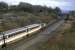 The up Inverness-Euston 'Clansman' is about to pass the lofty Plean signal box on a Saturday in March 1987. Loco 47457 is in charge of a smart looking rake of Mark 3 stock. This named train, the signal box and even the road bridge are now long gone.<br><br>[Mark Dufton /03/1987]