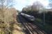 Looking east from Woodilee Village (built on the site of the former Woodilee Hospital) OHLE mast bases are already in place but so far only a solitary steel mast as an Edinburgh to Glasgow Queen Street DMU approaches on 22nd February 2016 [see image 8661].<br><br>[Colin McDonald 22/02/2016]