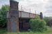 The Glasgow and South Western Railway's Barrhead Branch from Paisley passed under the Glasgow, Barrhead and Neilston Direct Railway below this bridge, just east of today's Barrhead station. In this view Barrhead station is to the right and Glasgow is to the left. The Shanks Works was behind the camera on either side of the closed line.<br><br>
The Barrhead Branch met a spur off the Direct line just beyond this bridge on the approach to the Barrhead Central terminus.<br><br>
The line from Paisley West was extended to Barrhead in a series of steps: Potterhill (1886), Gleniffer Goods (1899), Barrhead (1902). Barrhead Central closed in 1916, the Paisley-Barrhead traffic having been killed off by tram and bus competition. Closure to goods was in 1917, but the curve to the station from the Direct line remained until the 1950s. Of course the Caledonian's Paisley-Barrhead-Lyoncross line also fared badly never having opened to passengers.<br><br>[Ewan Crawford //1999]