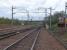 On the far left is the then new turnback siding complete with hump! Also showing (left to right) Down Millerhill and Up Millerhill lines and part of the Up yard with stabled Class 37 loco 37415 in EW&S livery.<br><br>
Whitehill Road bridge features in the middle distance from where railway photographers are wont to take their shots of trains moving to and from Millerhill Yard.<br><br>
Soon to be opened Newcraighall Station is visible in the centre distance beyond the A1 overbridge shown by the white platform edging.<br><br>
A close up shot of the turnout is also available [see image 54551].<br><br>[Charlie Niven 25/04/2002]