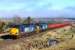 37607 and 37218 work the Georgemas Junction to Mossend engineering train away from Inverness. The wagons are full of old sleepers from Forsinard. In the background, a foggy Culloden.<br><br>[John Gray 17/03/2016]