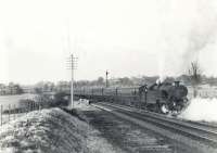 Fairburn 2-6-4T 42056 at the site of Lugton East Junction on 21 March 1962 with the empty stock of a Glasgow Central - Uplawmoor train. Photographed shortly before the withdrawal of passenger services between Neilston and Uplawmoor.  <br><br>[G H Robin collection by courtesy of the Mitchell Library, Glasgow 21/03/1962]