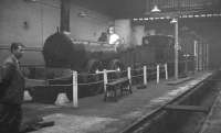 Furness Railway 0-4-0 No 3, built by Bury, Curtis and Kennedy of Liverpool in 1846, on display inside Horwich Works in 1960. Nicknamed <I>'Old Coppernob'</I> due to the copper cladding around its dome shaped firebox, it was latterly employed on local work around Barrow, before withdrawal in 1900. The locomotive shows some signs of shrapnel damage from German bombs, received while on display at Barrow station early in WWII. It was later moved to Horwich, where it remained until 1963, then to Clapham Railway Museum until 1975 and finally to the NRM in York, where it now forms part of the national collection. <br><br>[K A Gray //1960]