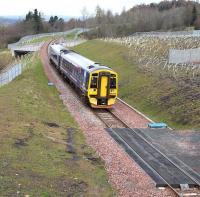 The 1011 Edinburgh - Tweedbank photographed between Newtongrange and Gorebridge on 10 April 2016. The train is about to run over the Network Rail access pad located to the south of Gore Glen Viaduct.<br><br>[John Furnevel 10/04/2016]