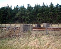 Concrete blocks on each side of the East Coast main line at Gravelpit Wood, 1 Km east of Ladybank which, together with a nearby pillbox, are what remains of a WWII defence post that would have enabled a barrier to be placed across the line.<br><br>[William Neill 04/04/2001]