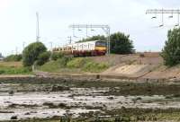 An Airdrie - Helensburgh Central train running along the north bank of the Clyde near Cardross in July 2004.<br><br>[John Furnevel 08/06/2010]