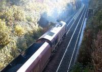 An EWS class 66 with a coal train on the sub in October 2003. The train is climbing past the remains of Craiglockhart station having just emerged from the tunnel under the Union Canal.<br><br>[John Furnevel 06/10/2003]