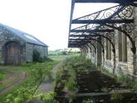 Scene at Whittingham station, Northumberland, on 29 May 2004. View is north along the island platform towards Wooler, with the old goods shed standing on the left. Whittingham station closed to passengers in September 1930.<br><br>[John Furnevel 29/05/2004]