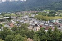Interlaken Ost, as seen from a descending car on the Harder-Kulm funicular. Standard gauge lines from the west and metre gauge lines from the south and east all terminate here. The platforms on the left are standard gauge with stabling roads and service depot beyond. The metre gauge BOB line curves in from the far right of the picture past the blue and yellow stock. In the middle another metre gauge line, the Zentralbahn from Luzern, can also be seen dropping down from an embankment alongside the stabling roads.<br><br>[Mark Bartlett 19/06/2016]
