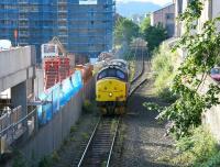 A fine summer morning in July 2005 sees EWS 37427, running light engine from Millerhill to Powderhall depot, approaching its destination. The locomotive had been diagrammed to work the morning <I>Binliner</I> to Oxwellmains. [See image 4773] <br><br>[John Furnevel 14/07/2005]