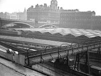 The south end of the footbridge that once spanned Waverley station between Calton Road and Jeffrey Street. The bridge was 'temporarily closed' in the 1950s and gradually fell into disrepair. This view shows the Jeffrey Street end of the closed bridge on a wet day in the 1960s. The last remnants of the old bridge were removed from the Calton Road entrance during the roof renewal works in 2013. [See image 6021] <br><br>[John Furnevel Collection //]