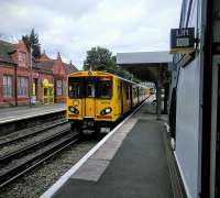 A Liverpool Central service calls at Birkenhead North on 30/06/2016. Birkenhead is well supplied with stations, if nothing else.<br><br>[David Panton 30/06/2016]