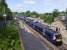 A six-car service from Glasgow Queen Street Low Level to Waverley pulls into Polmont on 24/05/2016. Photographed from the road bridge recently ratcheted-up to accommodate electrification (see advancing masts in background). The footbridge behind me has been electrification-ready for overs 50 years. That's planning.<br><br>[David Panton 24/05/2016]