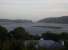 Looking down from the coastal highway, the Knysna lagoon at the Eastern end of the famous, and now closed, George to Knysna 'Garden Route' can be clearly seen. The railway viaduct across the lagoon is visible above the house roof and trees. The scenery and vegetation are quite reminiscent of Scotland at this end of the line.<br><br>[Ken Strachan /08/1994]