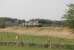 The barriers on the New Road AHB level crossing at Silverdale are rising behind the train as 57003 and 57301 take the evening flasks from Sellafield to Crewe on 12th May 2016. The train is passing the RSPB Reserve at Leighton Moss heading towards Carnforth.<br><br>[Mark Bartlett 12/05/2016]