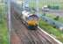 Coal empties approaching Carstairs from the south in the summer of 2006 behind EWS 66203.<br><br>[John Furnevel 11/07/2006]