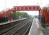 A wet Sunday morning in May 2006 looking east along the platforms at Blaydon station. The outline of Blaydon signal box can just be seen in the background between the signal and the road bridge. This was the point where the old main line turned north to cross the Tyne on Scotswood Viaduct [see image 9261].<br><br>[John Furnevel 07/05/2006]