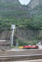 An impressive backdrop to the SBB loco depot at Biasca, at the southern end of the Gotthard pass, where three diesel shunters were stabled in the depot yard in June 2016. The final drop of the waterfall is actually two separate cascades that cross each other.<br><br>[Mark Bartlett 25/06/2016]