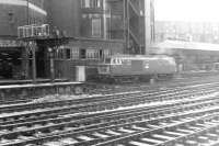 Hymek D7058 standing alongside Paddington Arrival signal box in the 1960s. Occupying the area in the background on both sides of the box is the large Paddington Parcels Depot, complete with its own platform. [See image 41238] <br><br>[Dougie Squance (Courtesy Bruce McCartney) //]
