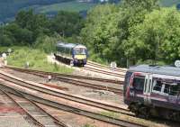 Scene to the north of Stirling station on the afternoon of 12 June 2008. In the background a train from Glasgow Queen Street turns north east on the last leg of its journey to Alloa, while in the foreground a Dunblane - Edinburgh train is slowing for the Stirling stop.<br><br>[John Furnevel 12/06/2008]