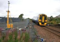 Seen looking west from the corner of the SPT car park at Shotts on 31 August 2016, a Glasgow bound Class 158 DMU passes the rail access point recently constructed as part of the large contractor's compound for the works at Shotts station.<br><br>[Colin McDonald 31/08/2016]