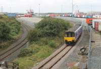 150119 leaves Heysham Port with the daily boat train to Leeds via Lancaster on 31st August 2016. The Sprinter has just connected with the IOMSP <I>MV Ben-my-Chree</I> from Douglas, moored alongside the station. [See image 20421] taken from the same spot almost eight years to the day previously, since when freight traffic through Heysham has grown considerably.<br><br>[Mark Bartlett 31/08/2016]