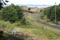 Leith South yard on 7 September 2016, seen from the high level trackbed of the Caledonian Leith East Goods branch. No signs of recent life in the yard, with the vehicles in the foreground alongside the south wall having become rather overgrown since they first arrived some 10 years ago. [See image 13862]. <br><br>[John Furnevel 07/09/2016]
