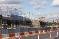 A TPE Class 185 crosses the viaduct carrying the line from Ordsall Jct to Salford Crescent on 8 October 2016. To the right of the train a line of grab bags marks the spot where the new Ordsall Chord leaves the existing line and crosses above the camera to the new junction facing Deansgate.<br><br>[John McIntyre 08/10/2016]