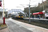Patches of rock salt decorate the platforms of Hamilton Central on a cold and frosty March morning in 2006 as SPT-liveried 318262 passes west below Quarry Street to arrive at platform 1 with a Larkhall - Dalmuir service.<br><br>[John Furnevel 17/03/2006]