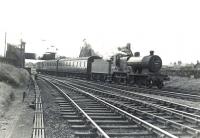 A Kilmarnock - Winton Pier train takes the left fork at Holm Junction after leaving Ardrossan South Beach station on 4 July 1959. The locomotive is one of Hurlford shed's Fowler 2P 4-4-0s no 40688, only 4 weeks from final withdrawal.  <br><br>[G H Robin collection by courtesy of the Mitchell Library, Glasgow 04/07/1959]