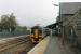 A Sunday morning service for Aberystwyth waits for departure time in the Down platform at Machynlleth. Unit 158832 has just come off the adjacent depot to start its diagram for the day. The Corris Railway narrow gauge station was just behind and below the Up platform but the site is now occupied by a business park, which can just be seen over the fence.<br><br>[Mark Bartlett 18/09/2016]