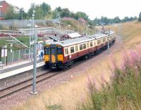 SPT liveried 318251 arrives at Merryton, the first stop out from Larkhall terminus, on 18 August 2006 with a train for Dalmuir. Merryton is essentially a large housing development on the northern edge of the Lanarkshire town, with the stations just over half a mile apart. <br><br>[John Furnevel 18/08/2006]