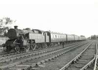 The empty stock of a Glasgow Central - Uplawmoor train at Lugton East sidings on 15 June 1961. Locomotive is Polmadie shed's Fairburn 2-6-4 tank 42055.    <br><br>[G H Robin collection by courtesy of the Mitchell Library, Glasgow 15/06/1961]
