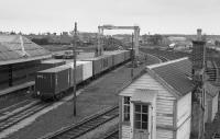 Looking over the GNSR yard at Elgin, past the disused signalbox.  A container train is under the gantry  To the right are some tank wagons with the former engine shed beyond.<br><br>[Bill Roberton //1991]