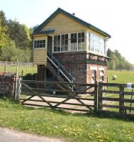 The surviving signal box at Cliburn, Cumbria, in May 2006. Located on the northern section of the Eden Valley line, the station closed to passengers in 1956 with the line itself closing completely 6 years later. View is east over the site of the old level crossing, with the former station building, now a private residence, located off picture to the right [see image 35003].<br><br>[John Furnevel 11/05/2006]