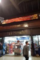 A banner above WH Smith advertises Glasgow Central Tour vouchers, the perfect Christmas gift. <a target=external href=https://www.glasgowcentraltours.co.uk/>Glasgow Central Tours</a>.<br><br>[John Yellowlees 02/12/2016]