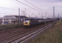 47445 passes the Leyland Trucks factory near Farington Junction with a Blackpool North to Manchester Victoria <I>Club Train</I> in the early 1980s. The siding serving the works was disused for many years but in 2016 became the location for a temporary DMU servicing point during the Blackpool line electrification works. The former D1561 was withdrawn in 1991 and scrapped by Booth Roe in Rotherham three years later. <br><br>[Mark Bartlett //1981]