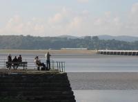 EE Type 3 37402, propelling a train from Carlisle towards the Kent Viaduct, is photographed by another enthusiast watching from the end of the stone pier at Arnside. This is the (SO) afternoon working that terminates at Lancaster, seen  on 15th October 2016.   <br><br>[Mark Bartlett 15/10/2016]