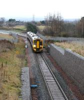 At 1022 on 18 December 2016, another one of those grey winter days when it never seems to achieve real daylight, the Sunday morning 0945 ex-Tweedbank comes off Hardengreen Viaduct and begins to slow for the Eskbank stop just behind the camera.<br><br>[John Furnevel 18/12/2016]