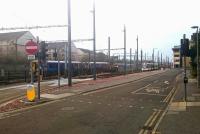 A murky morning at Haymarket Yards on 30 December 2016, with Haymarket station just off picture to the left. From left to right are the 0839 from Glenrothes with Thornton, the 0616 ex-Manchester Victoria and a city-bound tram from Edinburgh Airport.<br><br>[Andy Furnevel 30/12/2016]